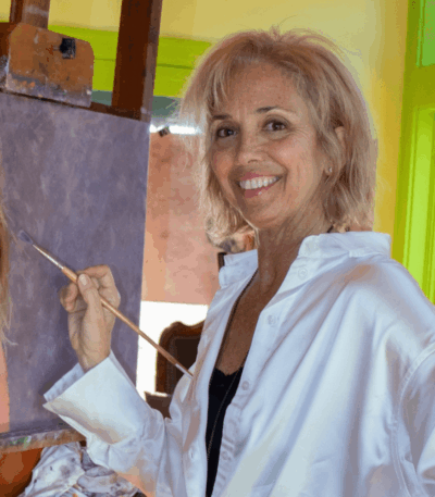 Catherine Hafer painting at her easel, award winning portrait artist and instructor preparing panels for her Fall 2025 workshop.