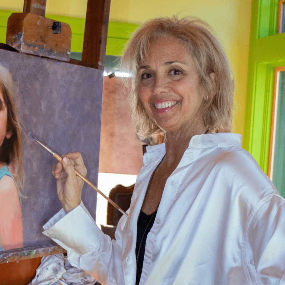 Catherine Hafer painting at her easel, award winning portrait artist and instructor preparing panels for her Fall 2025 workshop.