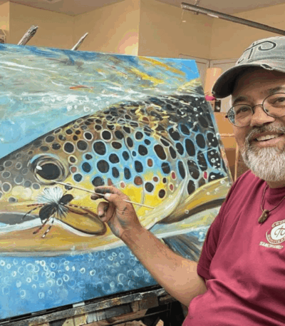 Duane Hada paints a detailed trout scene on a large Artefex all-in-panel in his studio during plein air workshop prep